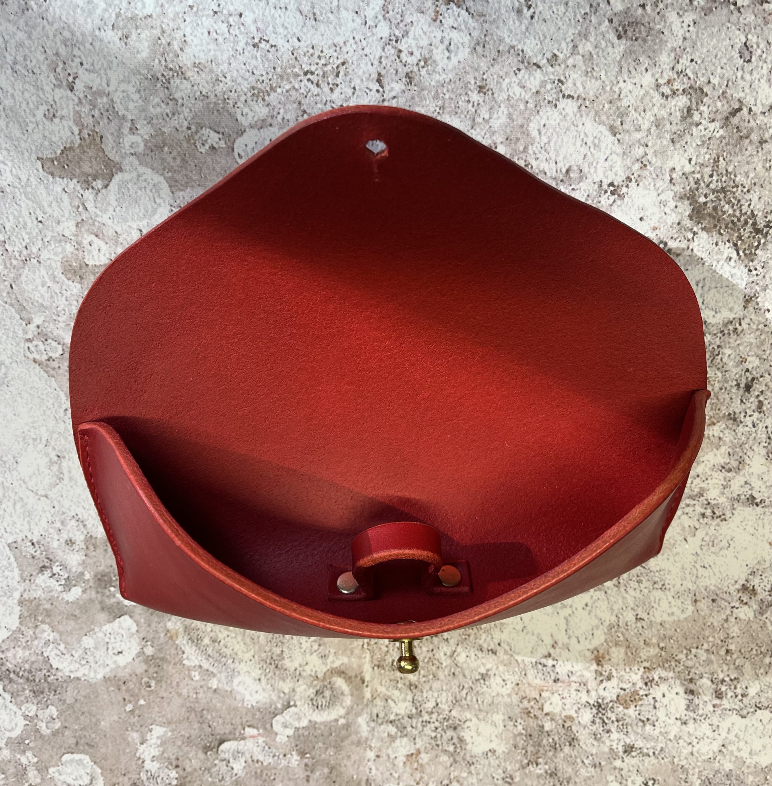 Showing inside of red leather sunglasses case